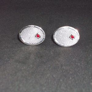 silver-tone cuff-link pair with red stone accent